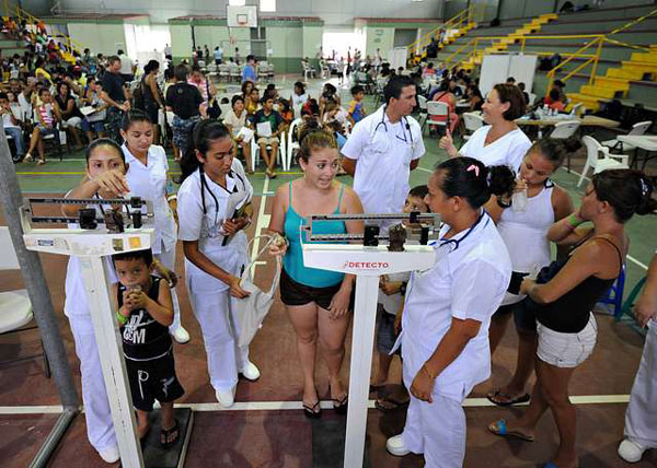 Enfermeras comunitarias atienden personas en un gimnasio