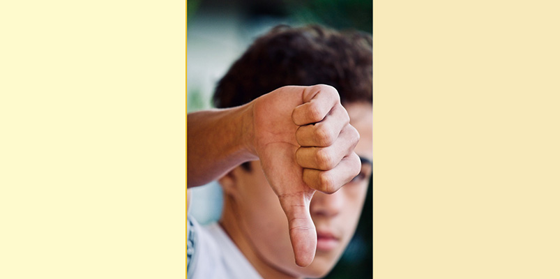 Persona con dedo pulgar apuntando hacia abajo